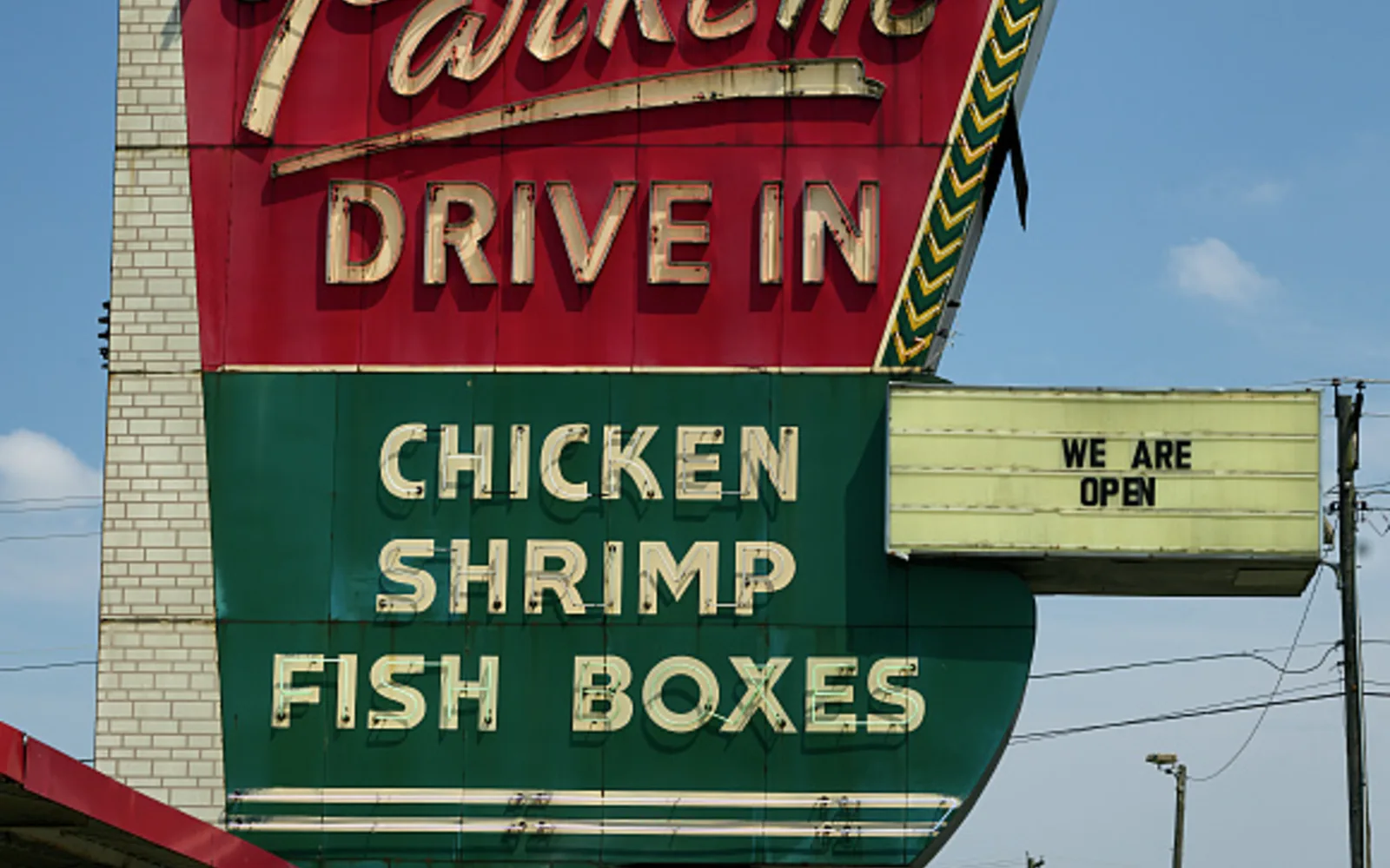 Exterior of The Parkette, a nostalgic 1950s-era drive-in restaurant with bright neon signage and classic mid-century architecture